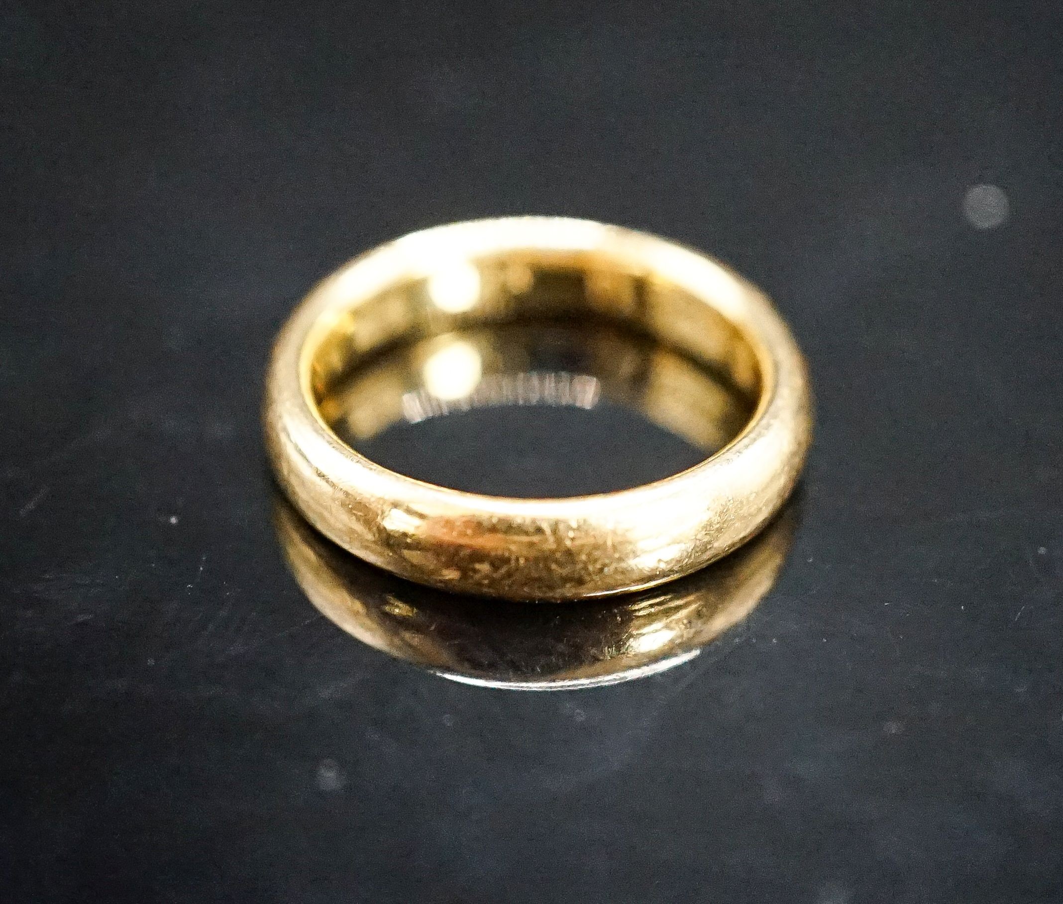 A 22ct. yellow gold wedding band, size L, 6.4 grams.